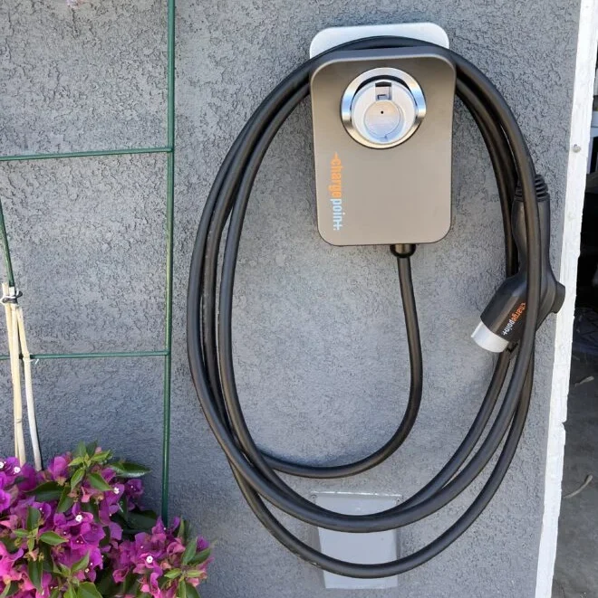 Wall-mounted electric vehicle charger with cable