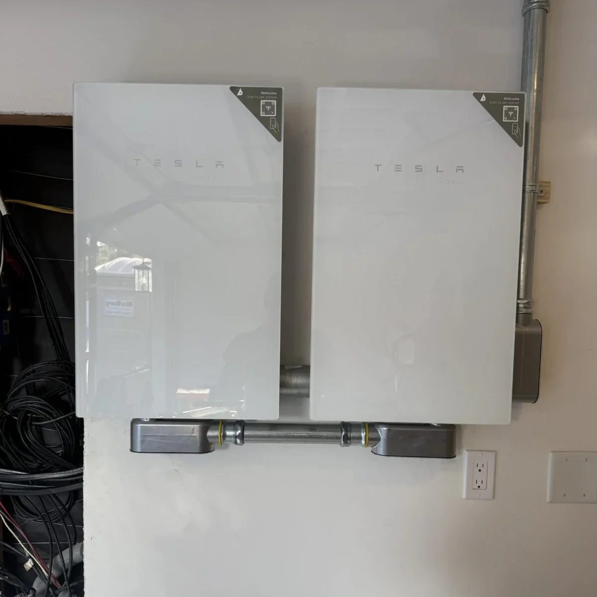 Two Tesla Powerwall battery units mounted on a wall